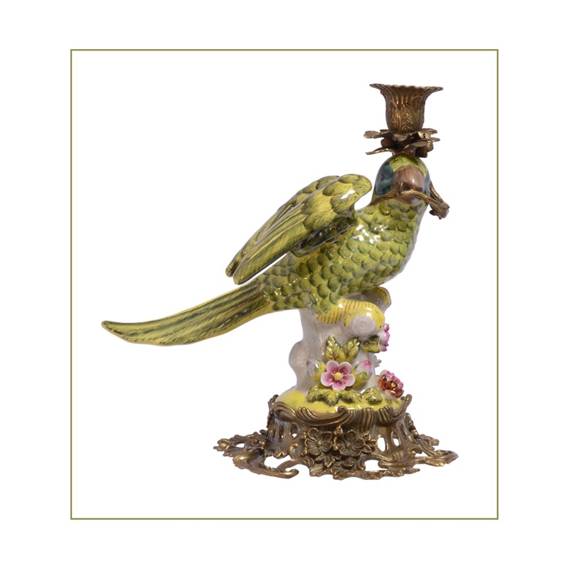 A BRASS MOUNTED PORCELAIN PARROT CANDLE HOLDER