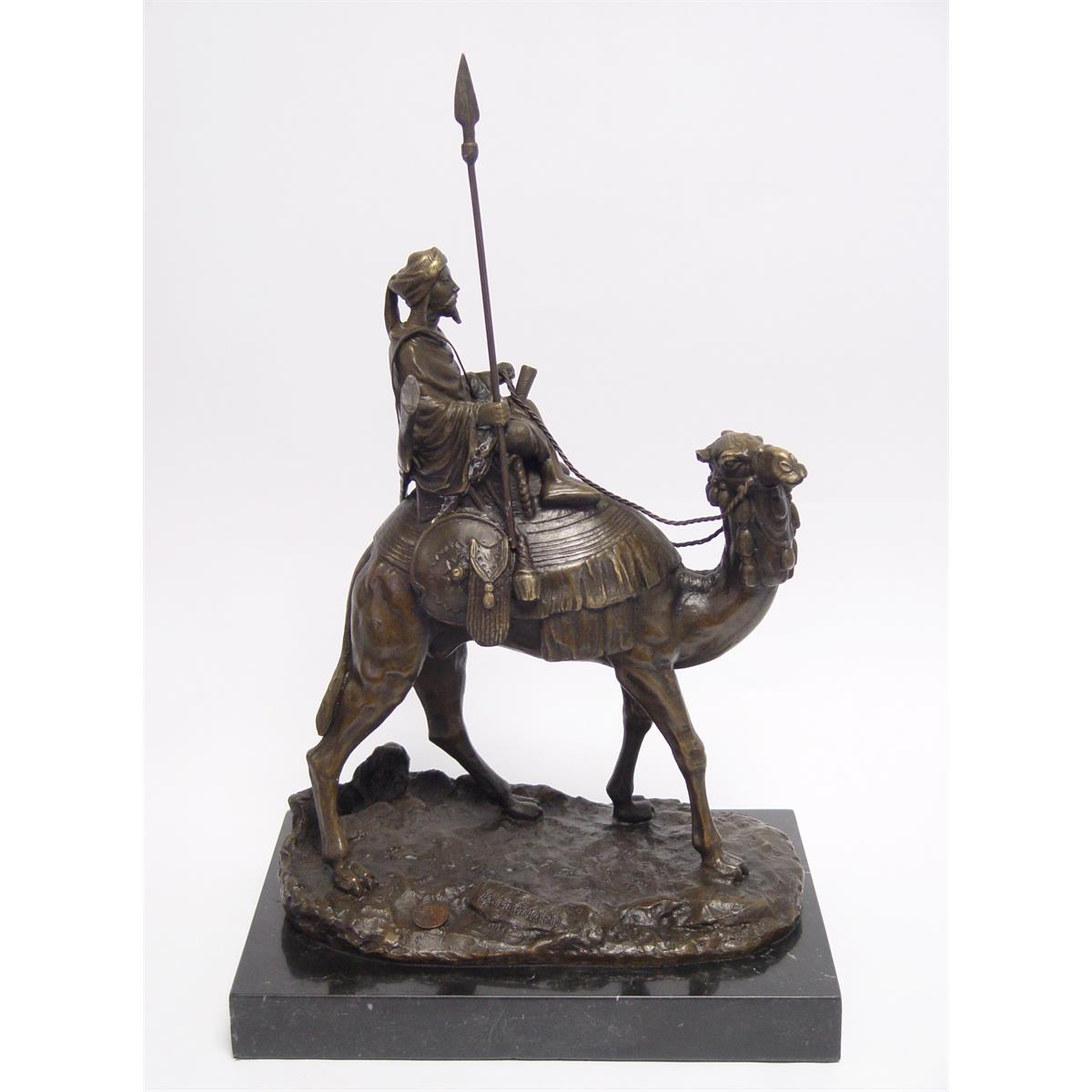 A BRONZE SCULPTURE OF A DROMEDARY AND RIDER